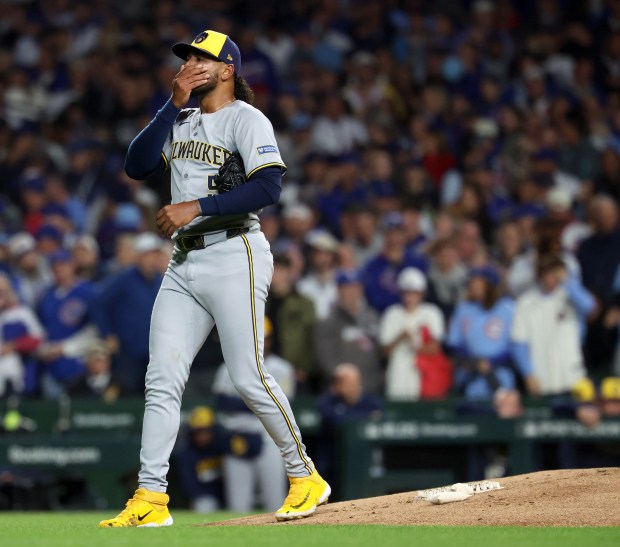 Milwaukee Brewers starting pitcher Freddy Peralta walks off the mound...