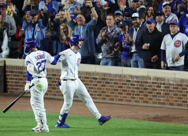 Cubs designated hitter Kyle Tucker, right, celebrates after hitting a...