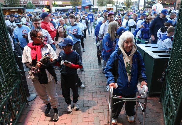 Fans wait to enter the ballpark for Game 4 of...