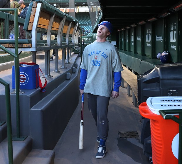 Chicago Cubs center fielder Pete Crow-Armstrong walks through the dugout...