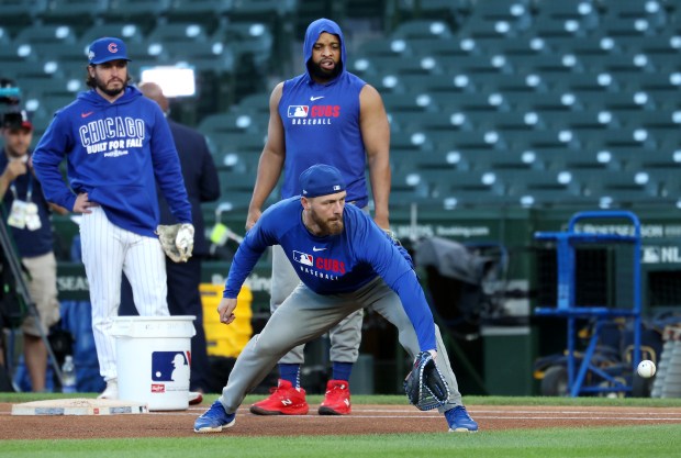 Cubs first baseman Michael Busch takes fielding practice before Game...