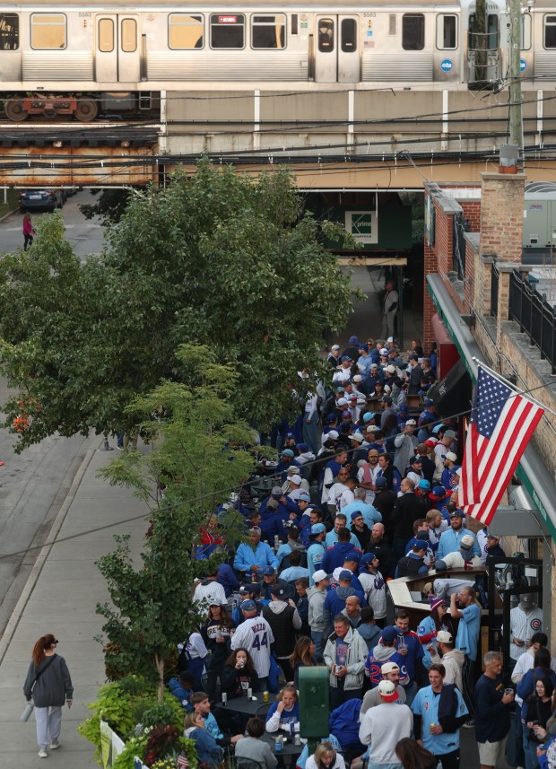 A CTA train passes as fans gather at a pub...