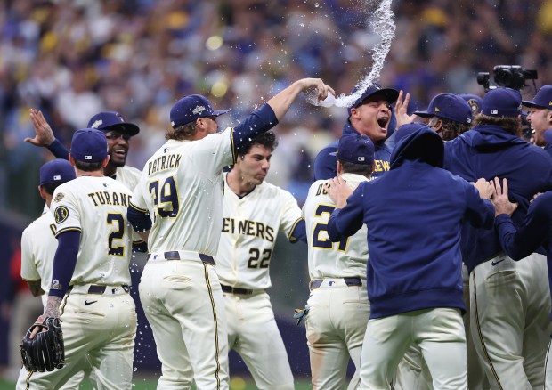 The Brewers celebrate their 3-1 victory over the Cubs in...