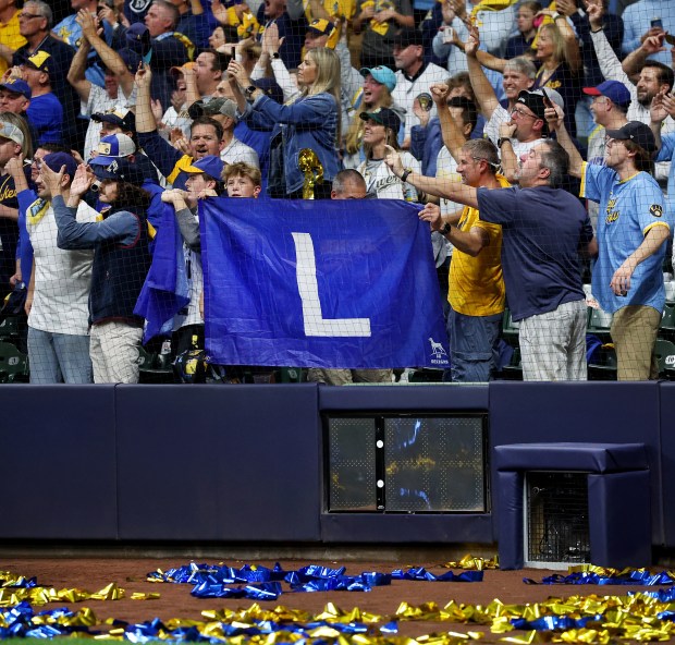 Brewers fans display an "L" flag after the Brewers defeated...