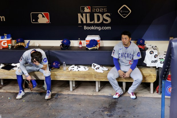 Cubs shortstop Dansby Swanson, left, and right fielder Seiya Suzuki...