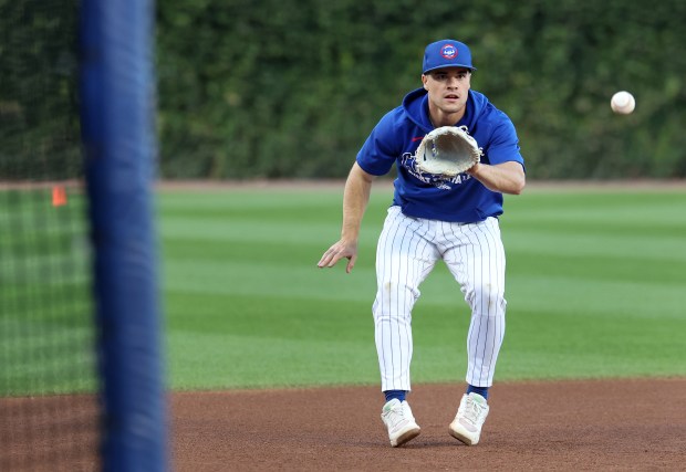 Cubs third baseman Matt Shaw takes fielding practice before Game...