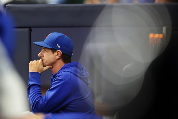 Cubs manager Craig Counsell looks out of the dugout in...