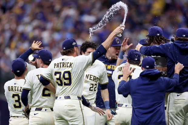 Reliever Chad Patrick (39) celebrates with teammates after the Brewers...