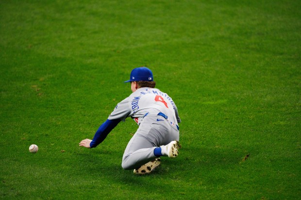 Chicago Cubs outfielder Pete Crow-Armstrong (4) falls while fielding a...