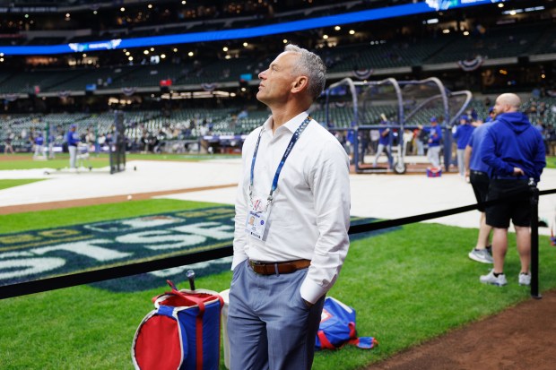 Cubs President Jed Hoyer walks near the field before the...