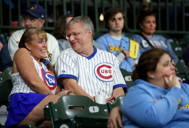 Chicago Cubs fans get comfortable in their seats before the...