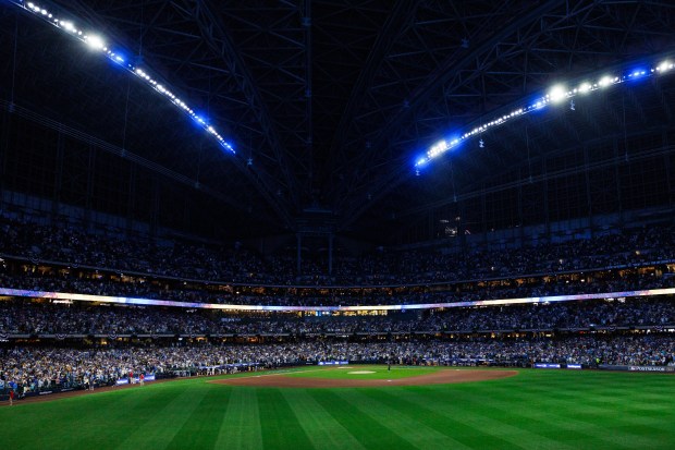 Lights illuminate the field during player introductions before the Cubs...