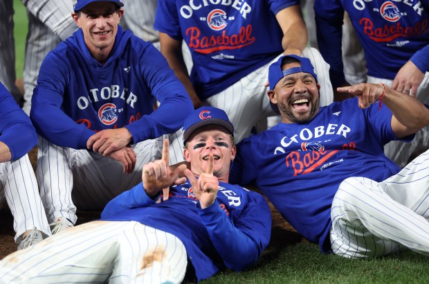 Chicago Cubs center fielder Pete Crow-Armstrong, bottom, and manager Craig...
