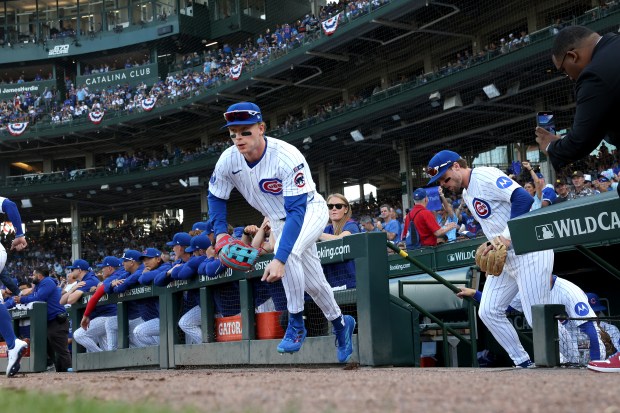 Cubs center fielder Pete Crow-Armstrong and teammates head out to...