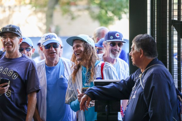 Fans wait to enter for the bleacher seats before Game...