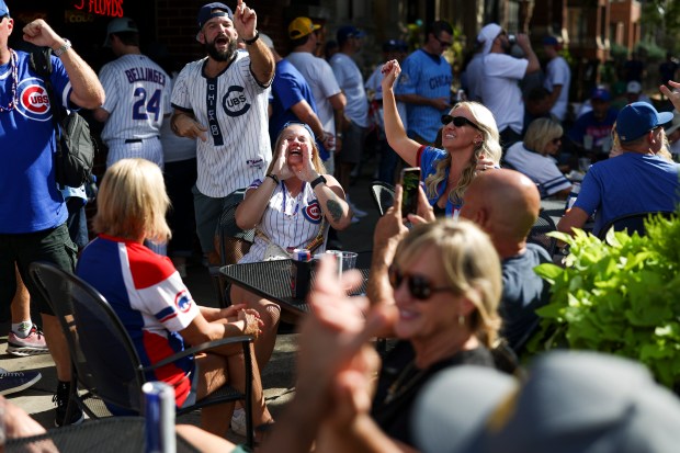 Cubs chant at Murphy’s Bleachers car before Game 3 of...