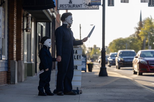 Evan Zimmerman, left, and his son Harrison Zimmerman, 7, stare...