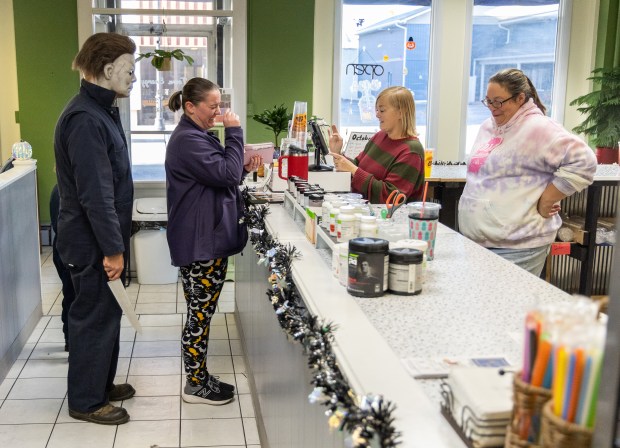 Evan Zimmerman, left, stands behind Kendra Ludwig, middle, of Decatur...