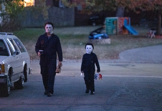 Evan Zimmerman, left, and his son Harrison Zimmerman to their home after buying food from McDonald's following an appearance at a horror movie trivia night, Oct. 9. 2025, in Decatur, Indiana. (Dominic Di Palermo/Chicago Tribune)