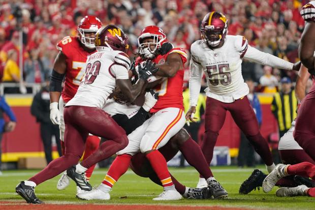 Kansas City Chiefs running back Kareem Hunt, center, scores as...