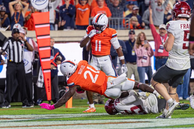 Virginia running back Harrison Waylee (21) scores a touchdown against Washington State during the second half of an NCAA college football game, Saturday, Oct. 18, 2025, in Charlottesville, Va. (AP Photo/Robert Simmons)