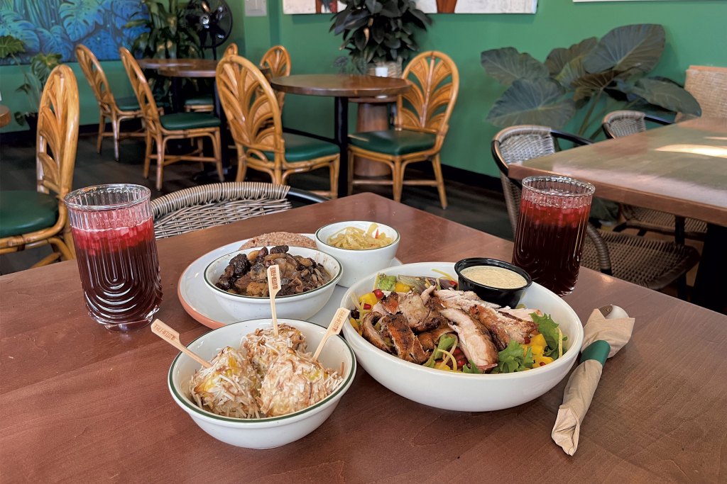 Clockwise from front: jerk corn, sorrel drink, oxtails and a Yaadie Signature jerk chicken salad at Thingz From Yaad Kitchen