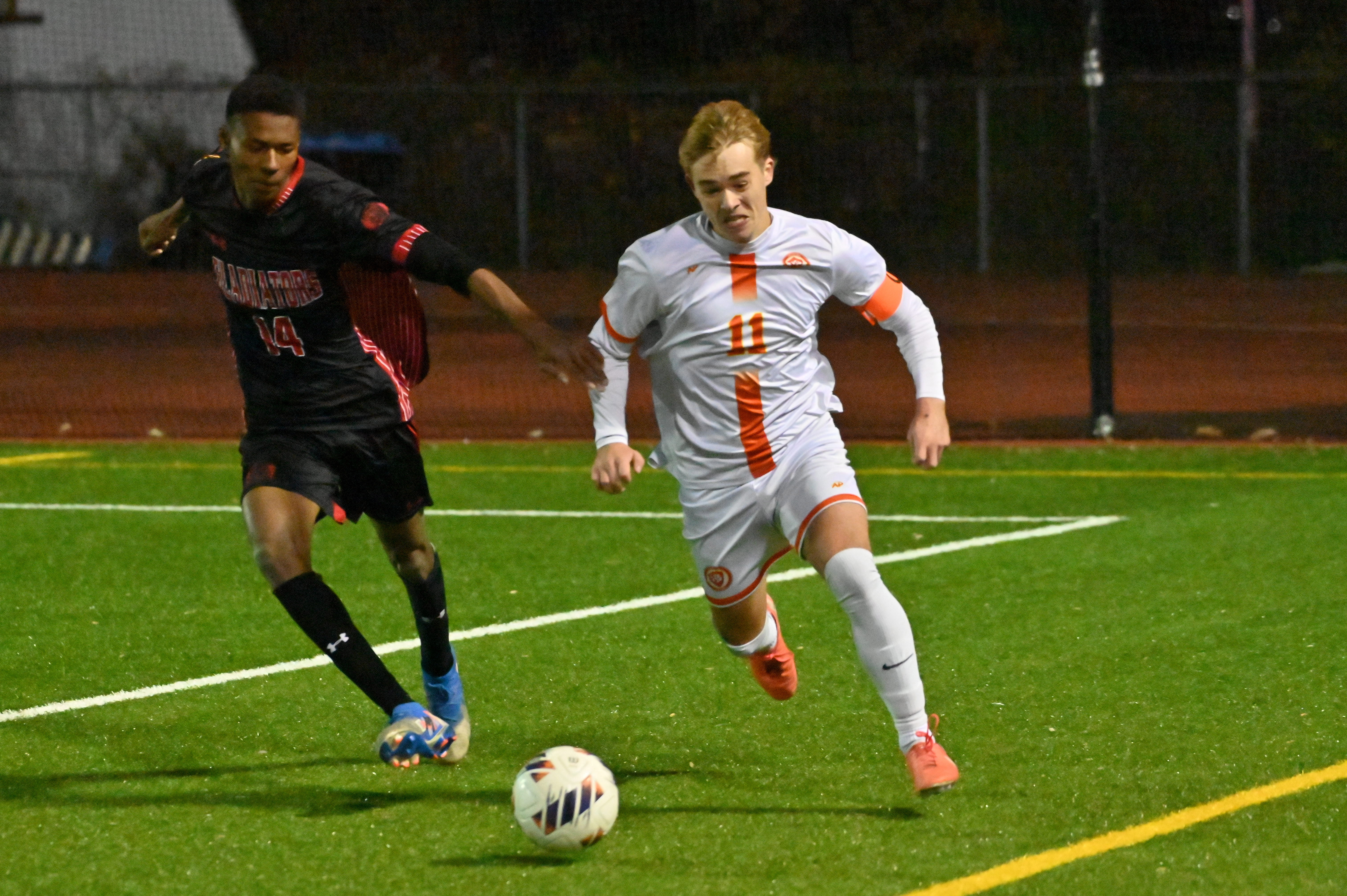 Glenelg 's Tito Tokunboh-Salako, left, tries to keep pace with Fallston's Levi Tanguay as he takes off with the ball during the Class 2A boys soccer state championship game at UMBC on Thursday. (Brian Krista/Staff)