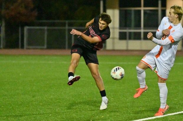 Glenelg's Michael Radek plays the ball as Fallston's Levi Tanguay positions himself to block the kick during the Class 2A boys soccer state championship game at UMBC on Thursday. (Brian Krista/Staff)