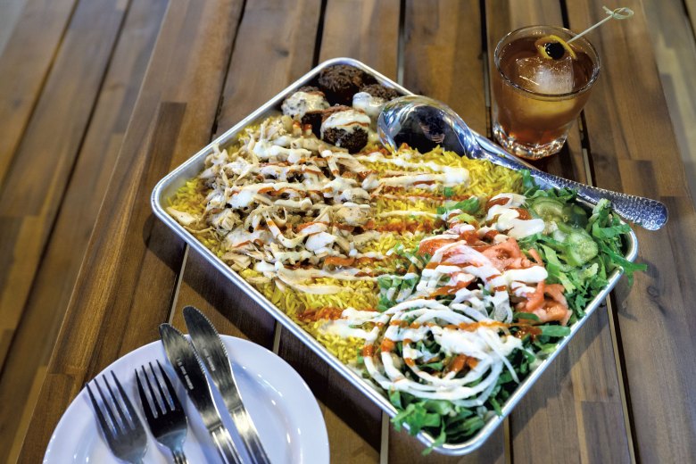 A family meal for two with chicken shawarma and falafel, and an old fashioned cocktail