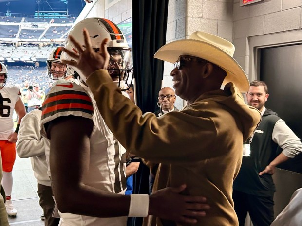 Colorado head football coach Deion Sanders, right, embraces his son, Cleveland Browns quarterback Shedeur Sanders before a game against the Las Vegas Raiders at Allegiant Stadium in Las Vegas on Nov. 23, 2025. Shedeur, who played at Colorado in 2023 and 2024, was making his first start in the NFL. (Brian Howell/Daily Camera)