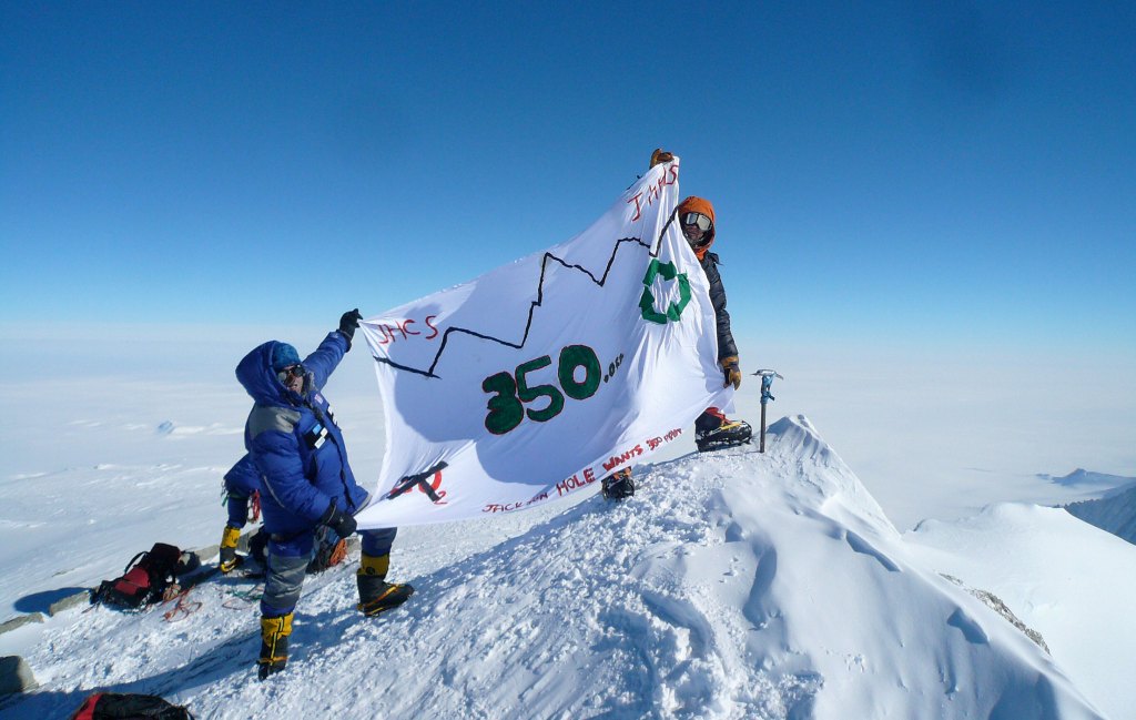 Climbers displaying a 350.org flag atop Antarctica’s highest peak