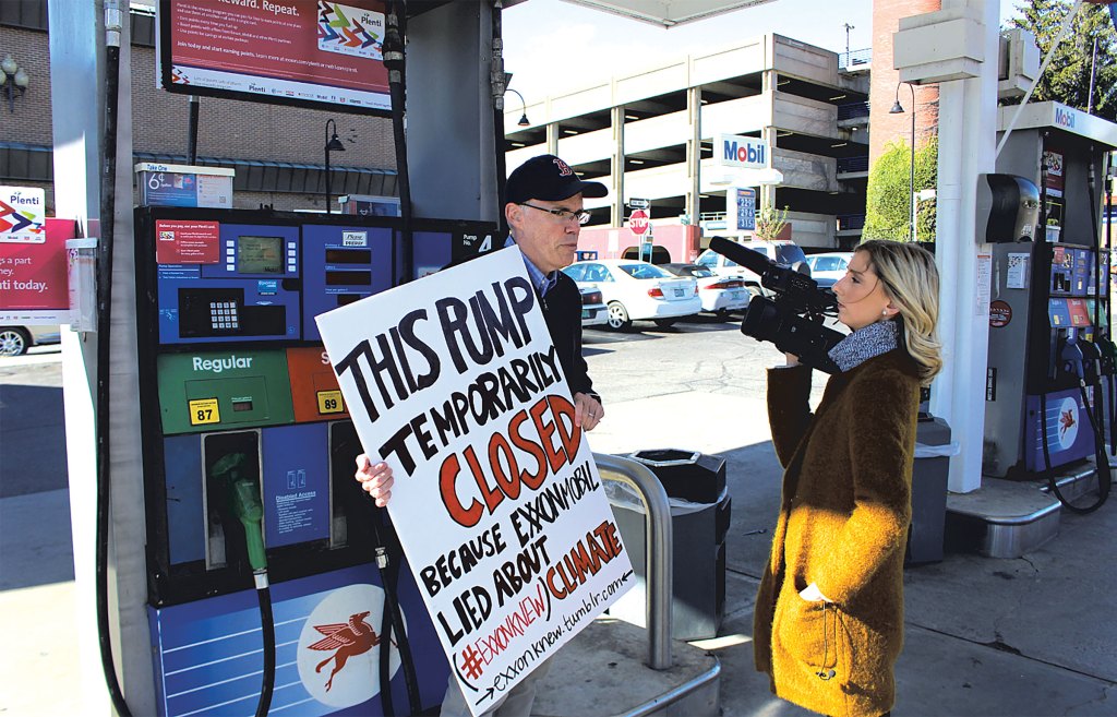 Bill McKibben protesting at a Burlington gas station in 2016