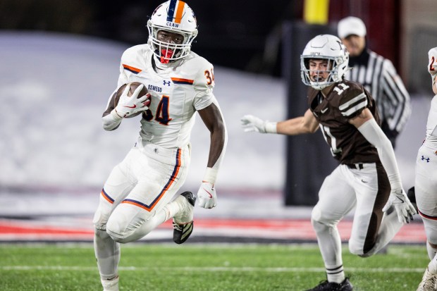 Oswego's Ammar Banire (34) picks up yards against Mount Carmel during the Class 8A state championship game in DeKalb on Wednesday, Dec. 3, 2025. (Vincent D. Johnson / for the Daily Southtown)