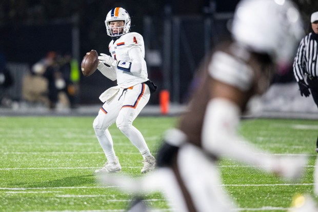 Oswego's Drew Kleinhans (4) drops back to pass against Mount Carmel during the Class 8A state championship game in DeKalb on Wednesday, Dec. 3, 2025. (Vincent D. Johnson / for the Daily Southtown)