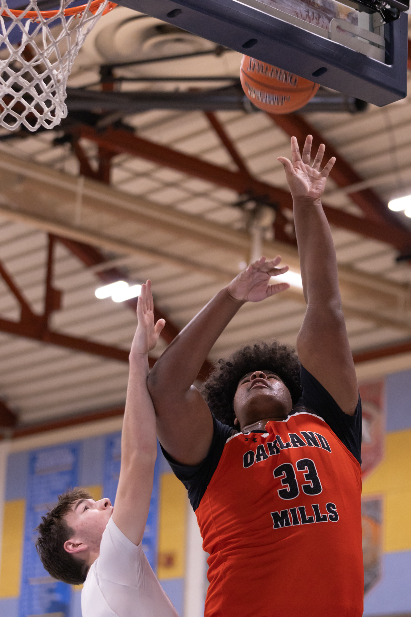 Oakland Millsâ Hayes Bishop puts up a shot from below...