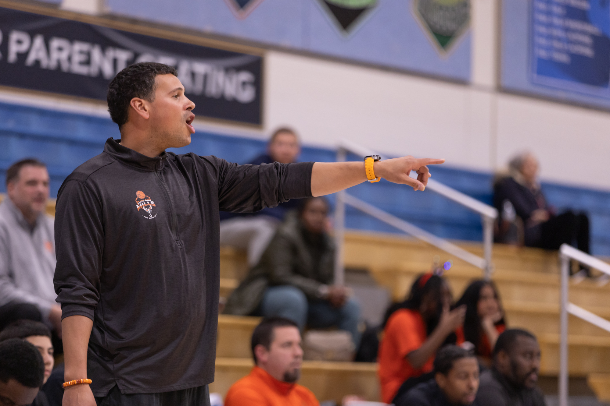 Oakland Mills head coach Kyle Harmon calls out to the...