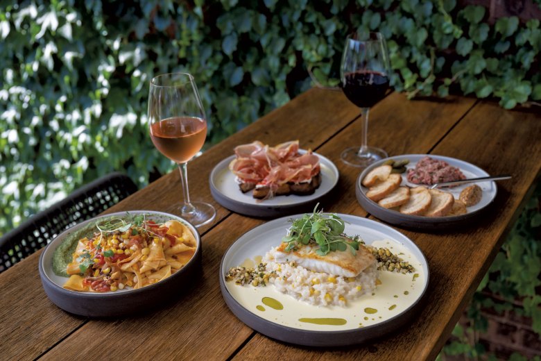 Clockwise from left: Papardelle, Clos Sainte Magdeleine rosé, tomato toast, Oddero “Convento” red wine, steak tartare and halibut at La Reprise