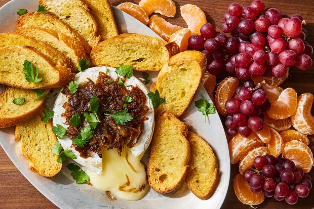 French onion baked Brie. Baked Brie is always a crowd-pleaser, but, in her version, Melissa Clark adds caramelized onions and loses the puff pastry. Food styled by Barrett Washburne. (Bryan Gardner, The New York Times)