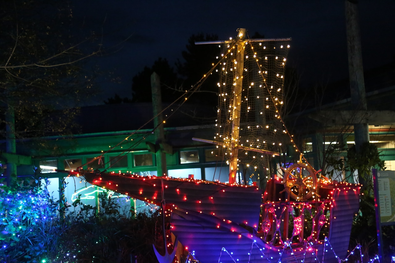 Holiday lights outline a ship at the Oregon Coast Aquarium