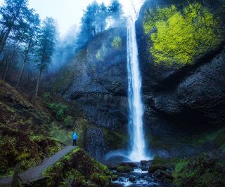 person standing at the base of Latourell Falls