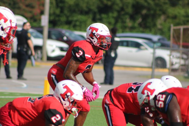 Lake Taylor outside linebacker DeVaughn Powell, center, leads Hampton Roads in sacks this season with 30. He's a big reason the Titans have advanced to the Class 3 state championship game. (Courtesy/Deirdre Powell)