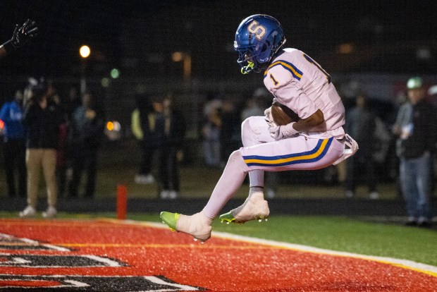 Oscar Smith receiver Travis Johnson (1) makes a leaping catch in the end zone for a touchdown. Oscar Smith defeated Nansemond River 35-21 at Nansemond River High School in Suffolk, Virginia, on Oct. 24, 2025. (Billy Schuerman/The Virginian-Pilot)