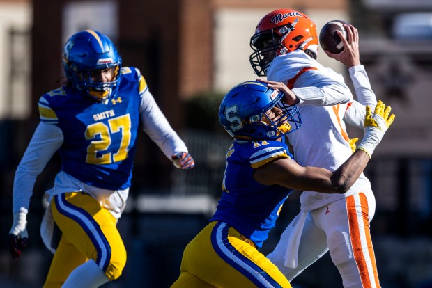 Oscar Smith linebacker Malachi White (11) pressures North Stafford quarterback Chase Sullivan (2) during a VHSL Class 6 championship game at James Madison University in Harrisonburg on Saturday, Dec. 13, 2025. (Kendall Warner/The Virginian-Pilot)