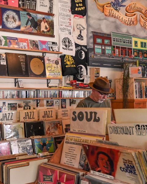 A man browses bins of records in a vintage record store