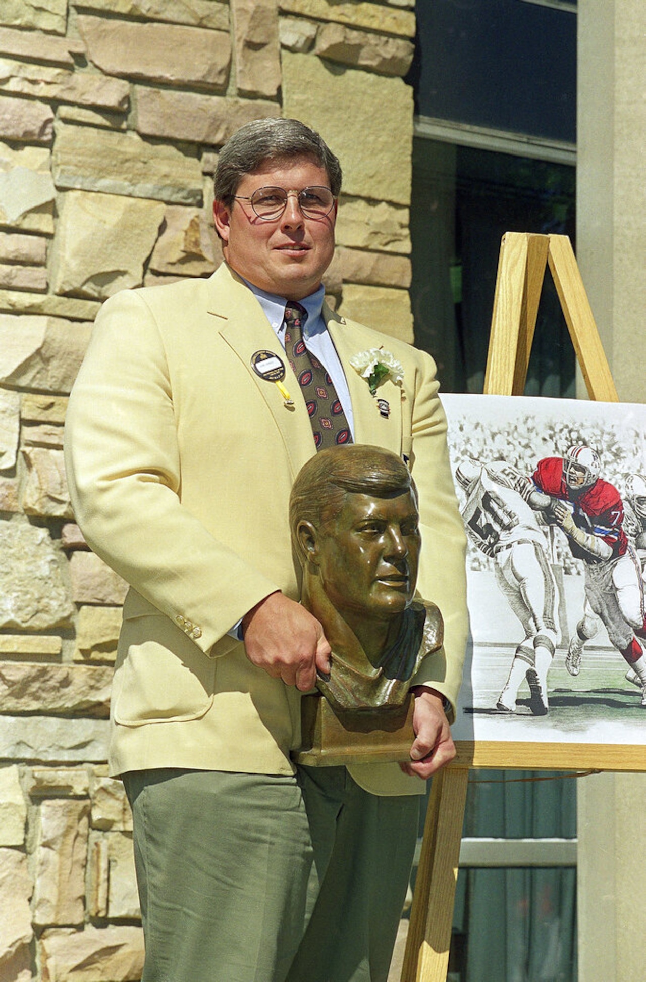 John Hannah of the New England Patriots poses with his bronze bust after being enshrined in the Pro Football Hall of Fame