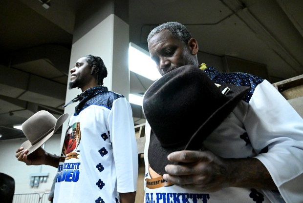 Rodeo clowns Wayne Rogers, right, and Johnny Yates, left, listen to the singing of the national anthem before taking part in the MLK Jr. African-American Heritage Rodeo at the National Western Stock Show in Denver on Jan. 20, 2025. (Photo by Helen H. Richardson/The Denver Post)