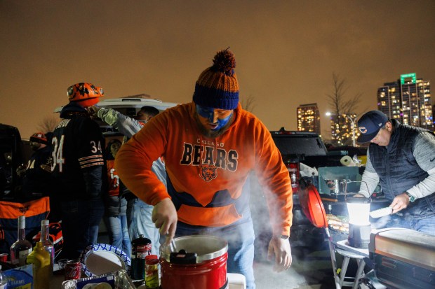 Kaden Carnes cooks Italian beef and sausages while tailgating before the Chicago Bears play the Green Bay Packers in a NFC wild-card game at Soldier Field Jan. 10, 2026 in Chicago. (Armando L. Sanchez/Chicago Tribune)