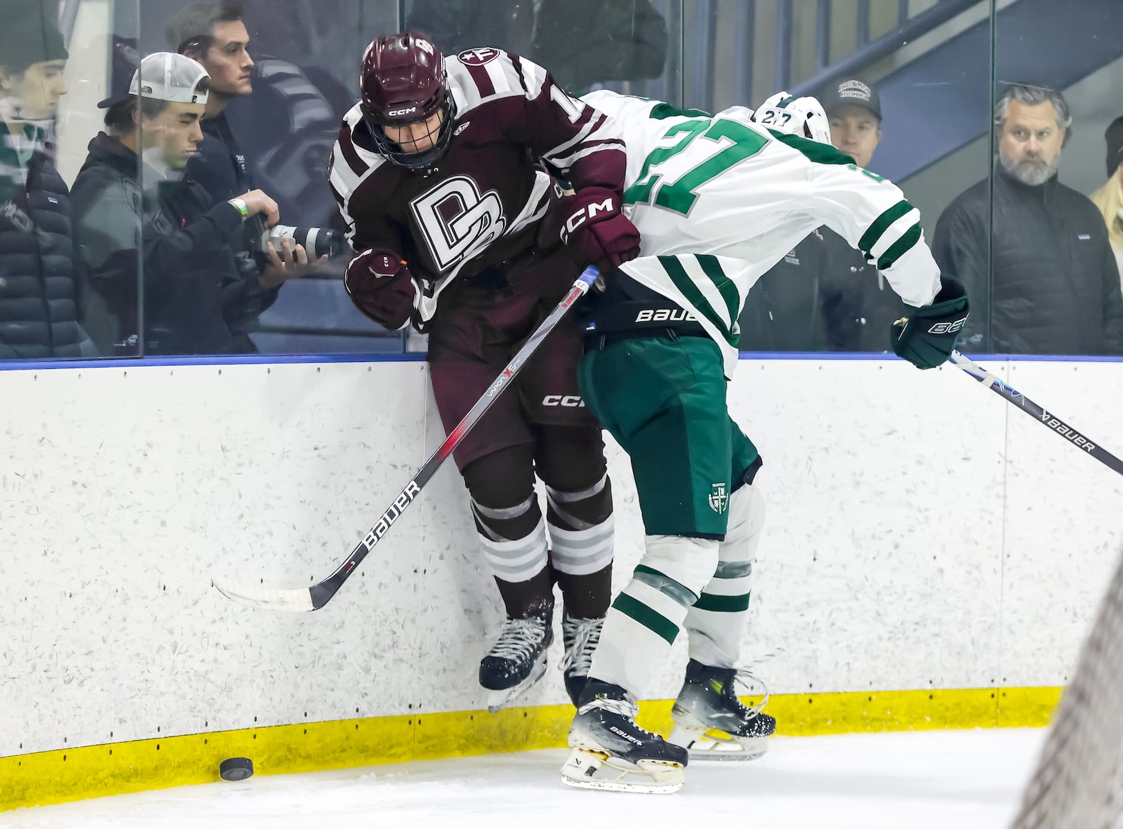 Marco Zimovcak (27) of Delbarton checks Chris Conklin (17) of Don Bosco Prep into the boards during the ice hockey game at Ice Vault Arena in Wayne, NJ On Sunday, January 11, 2026.
