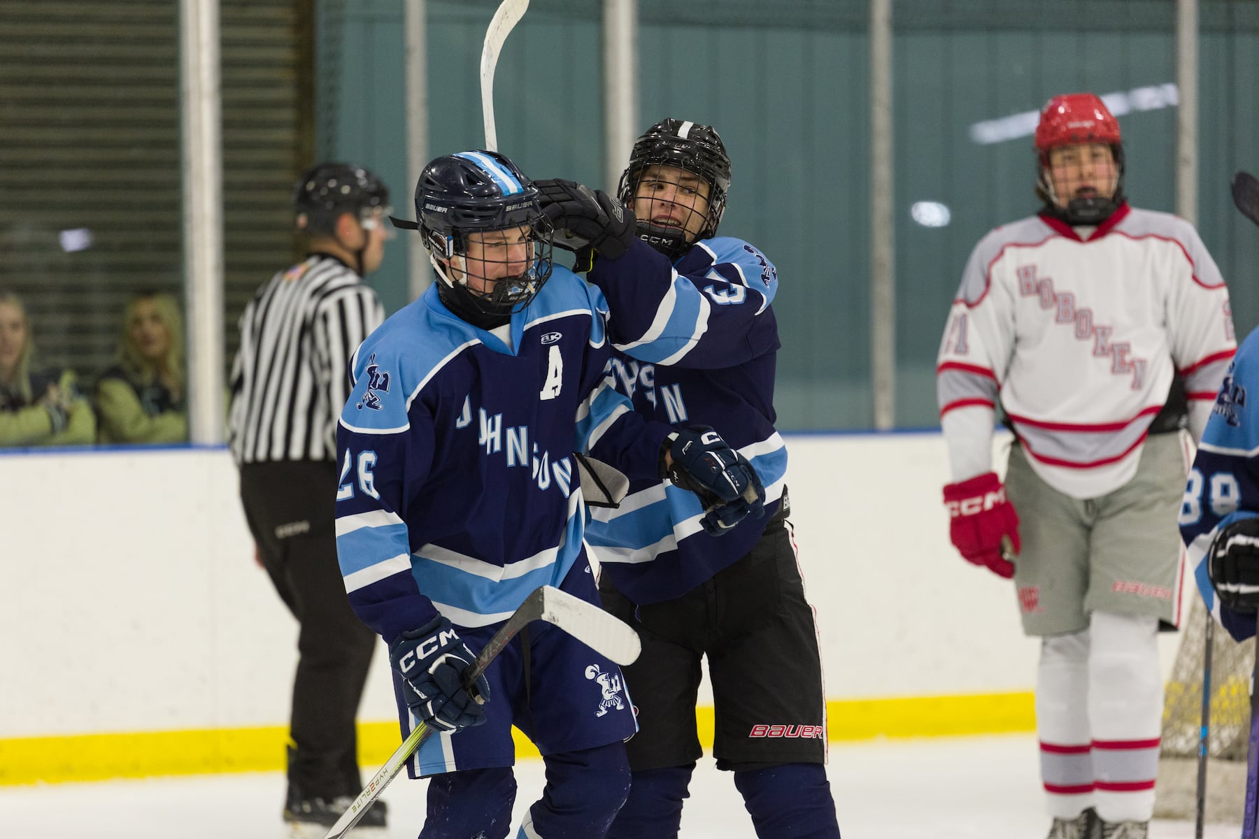 Logan Paskewich (26) and Jack Goldate of A.L. Johnson celebrate a score against Hoboken in Sunday's high school boys ice hockey showdown in Roselle. Johnson out-skated the Redwings 4-1.  01/11/2026