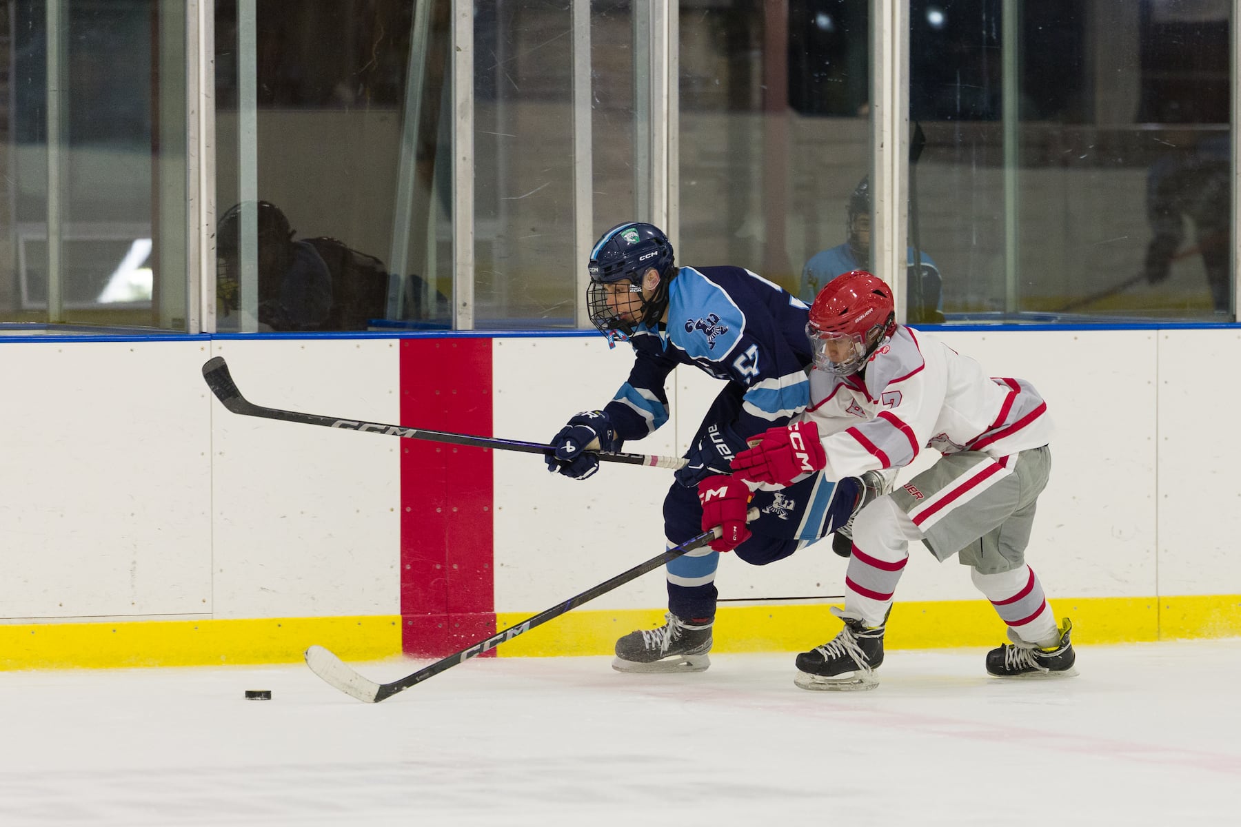 Logan Texidor of A.L. Johnson (57) speeds the puck past Hoboken's Jair Rodriguez (7) in Sunday's high school boys ice hockey showdown in Roselle. Johnson out-skated the Redwings 4-1.  01/11/2026